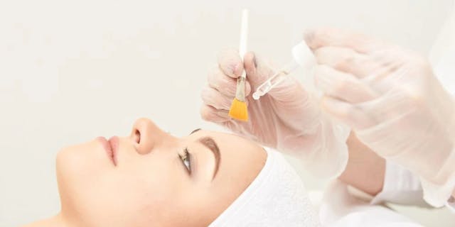 Beauty treatment with a brush and acid in a pipette