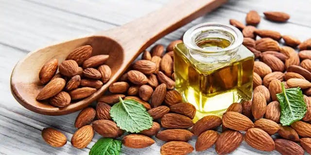 Sweet almond oil surrounded by almonds